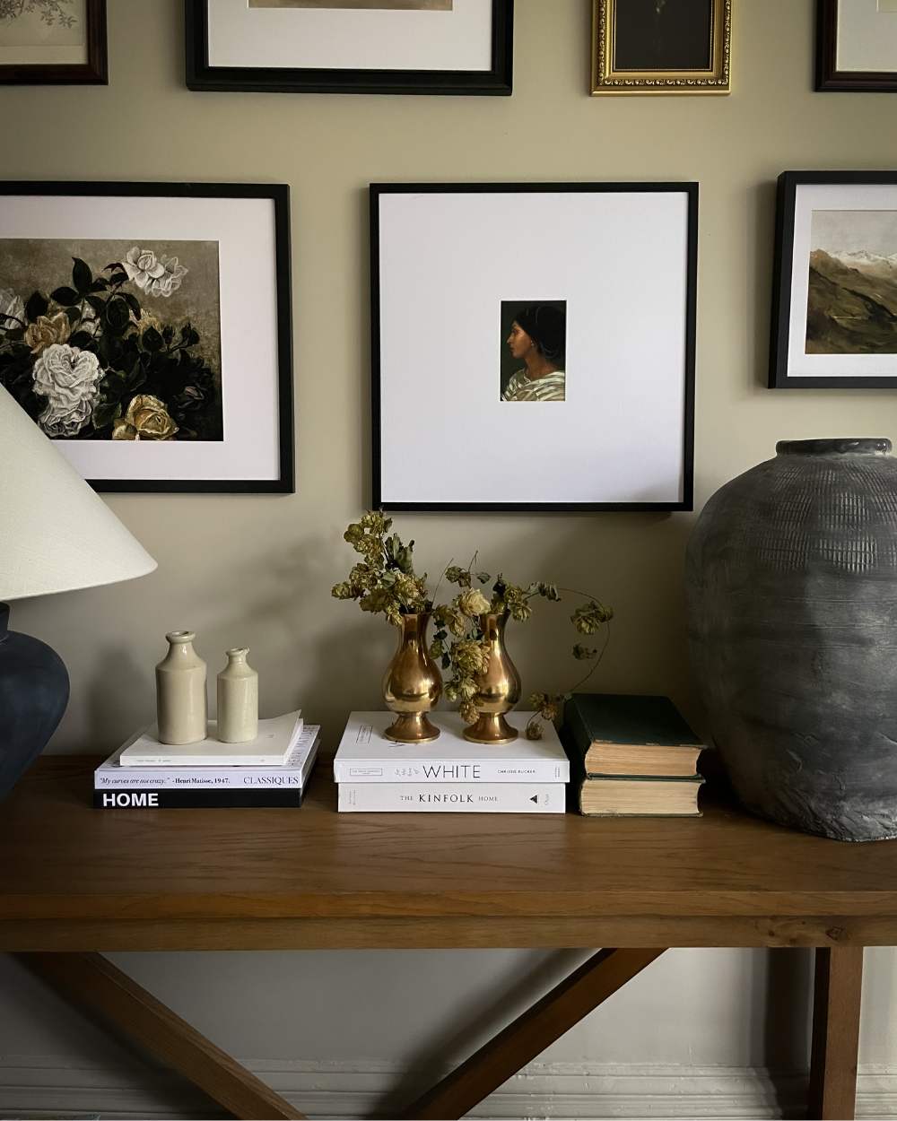 Brass vases on top of books from Wild in the Wold interior collections