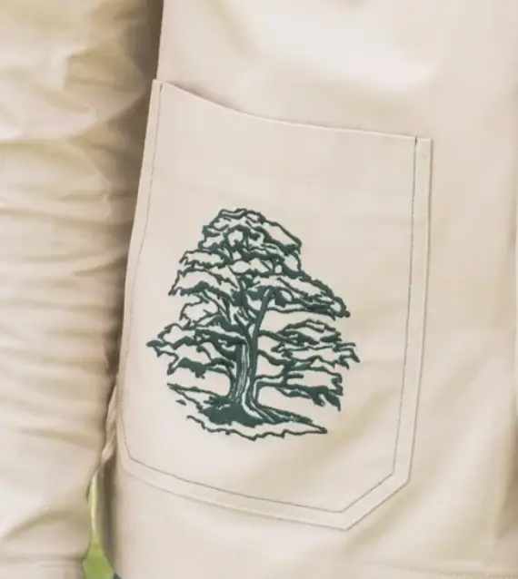 Embroidery detail of the Cedar Tree of Lebanon on a Limited Edition Herbs Work Jacket in Sand