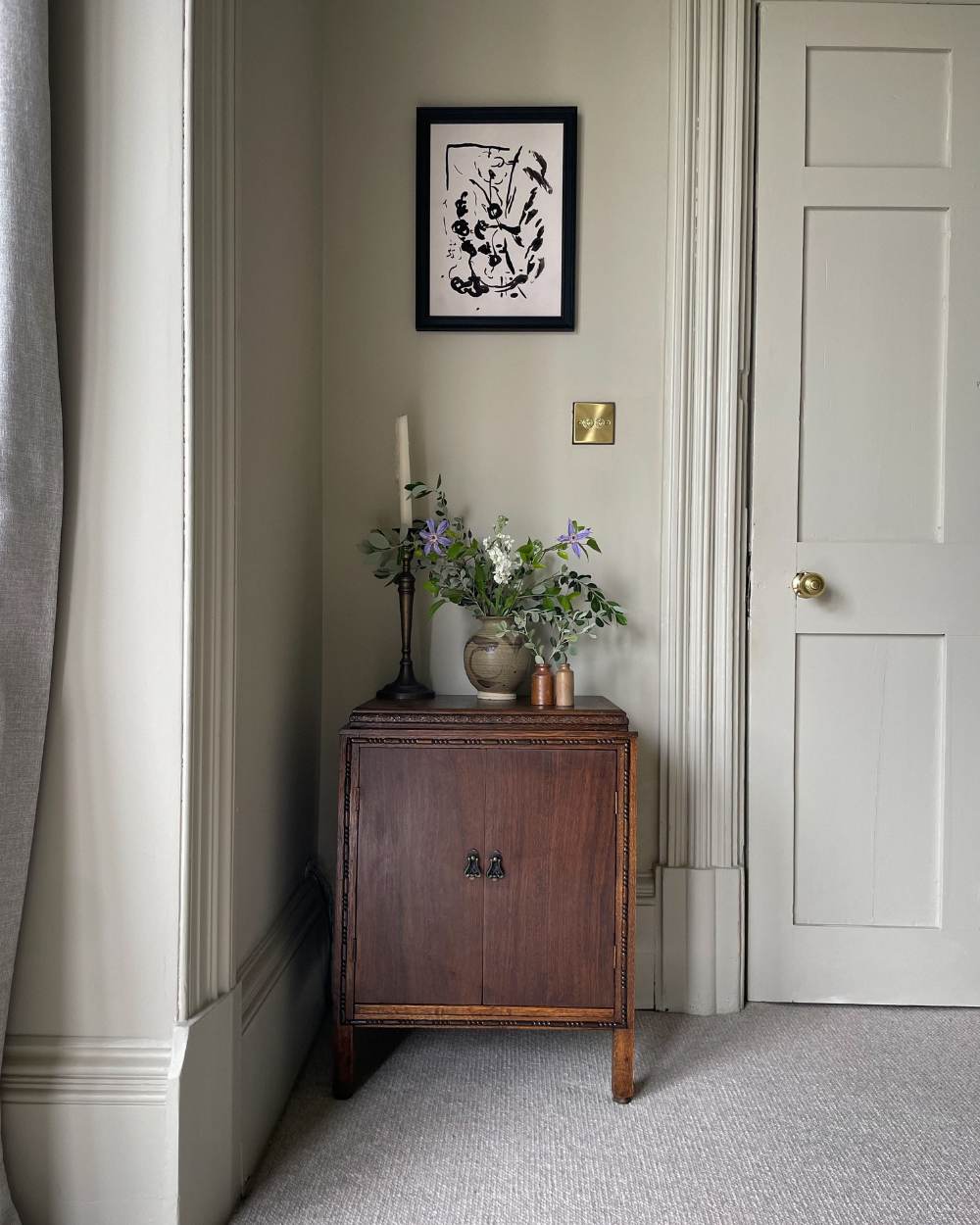 Antique oak music cabinet with vintage hand-thrown earthenware vase, stoneware inkwell canisters and a large antique brass candlestick holder from the Quiet Corner Interior Collection created by Wild in the Wolds