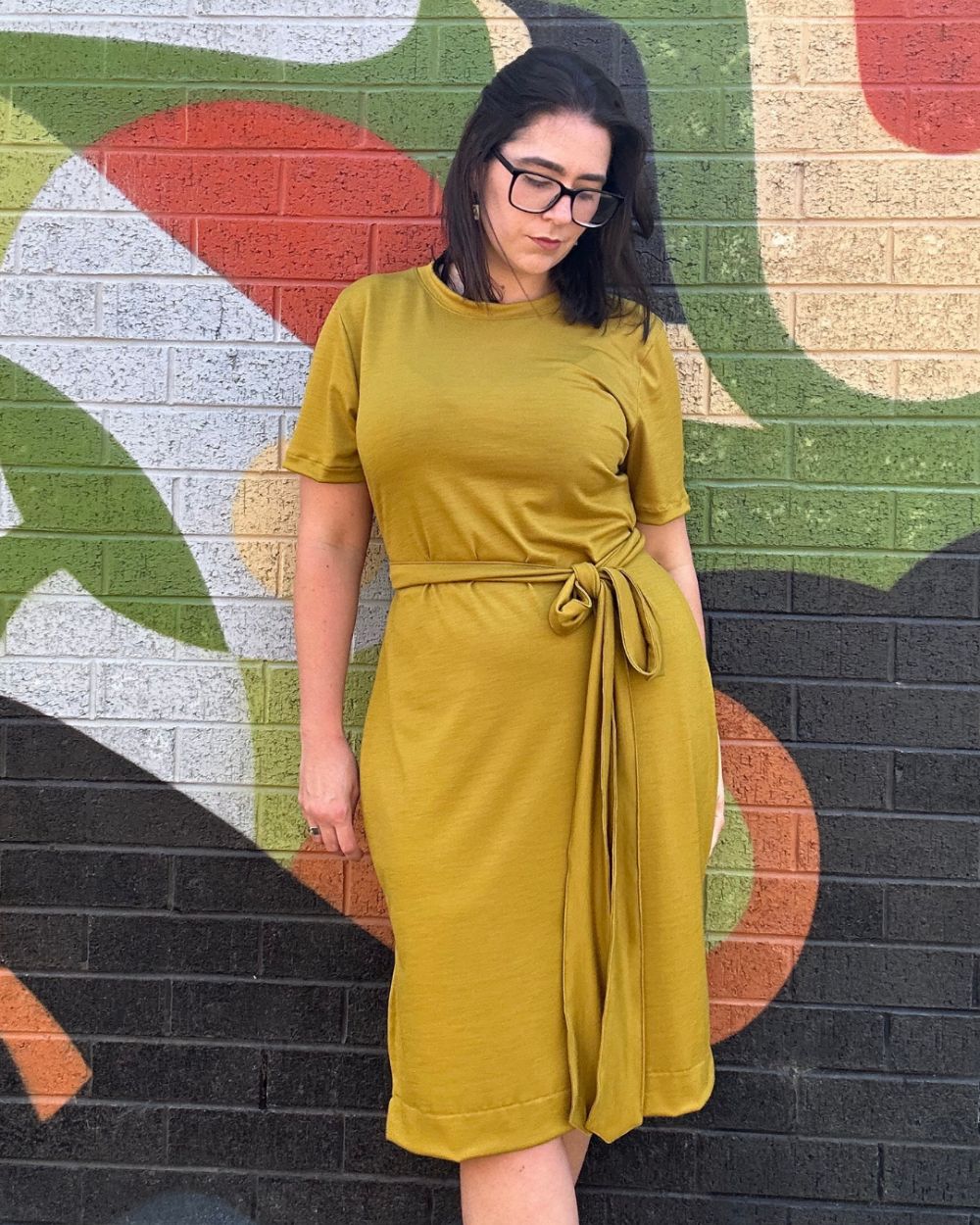 Annie Stafford wearing one of her creations, an olive green dress