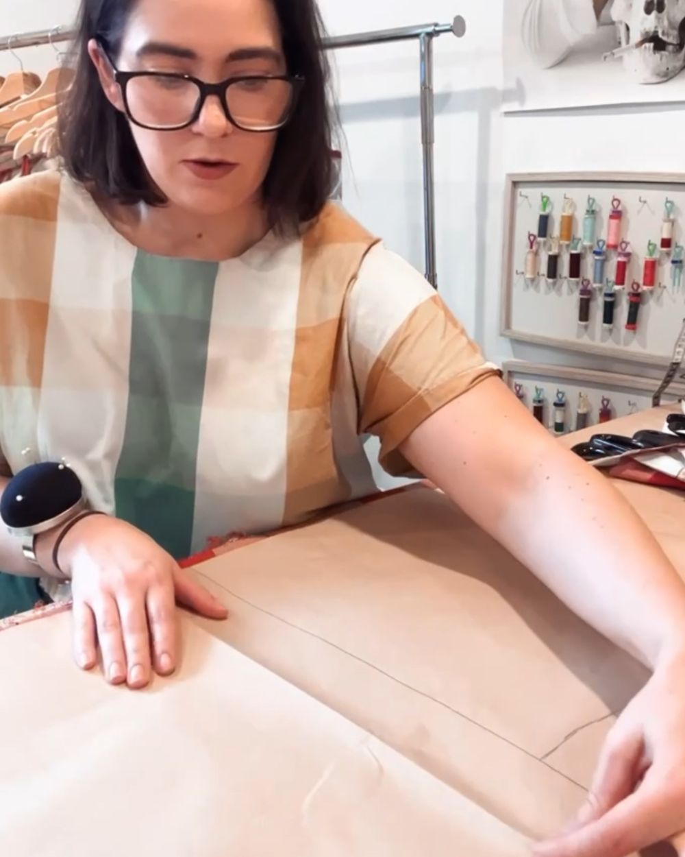 Annie Stafford working with sewing patterns