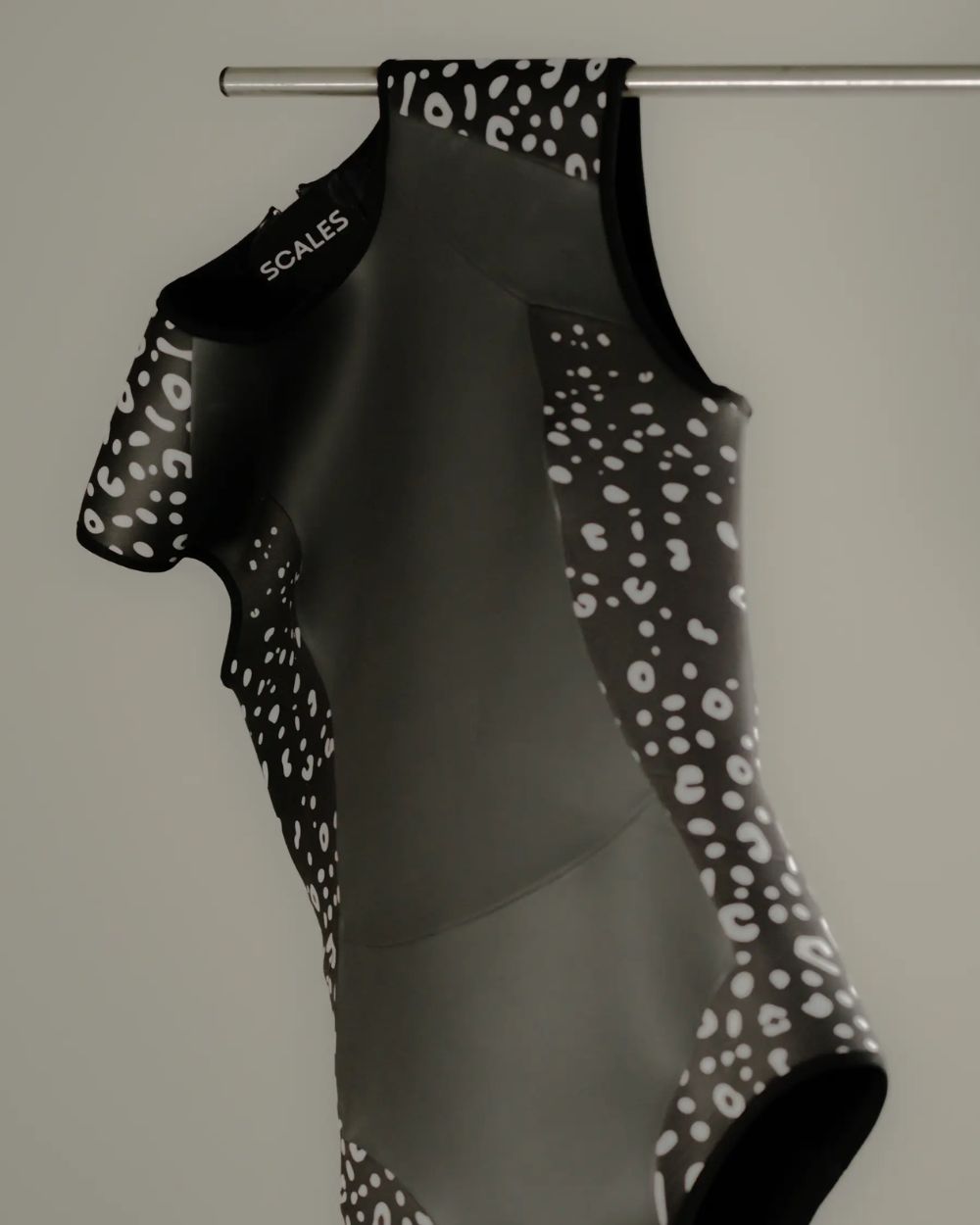 Scales SwimSkin water sportswear swimsuit hanging on a metal rod