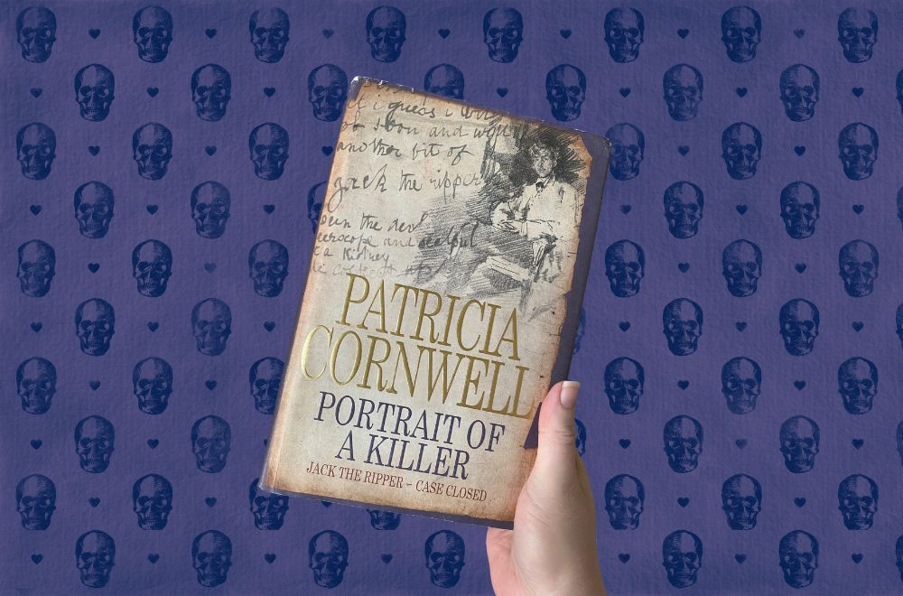 Portrait of a Killer: Jack the Ripper - Case Closed, book being held by a hand with a spooky skull print in dark blue in the background. Image courtesy of Cherie Cooper