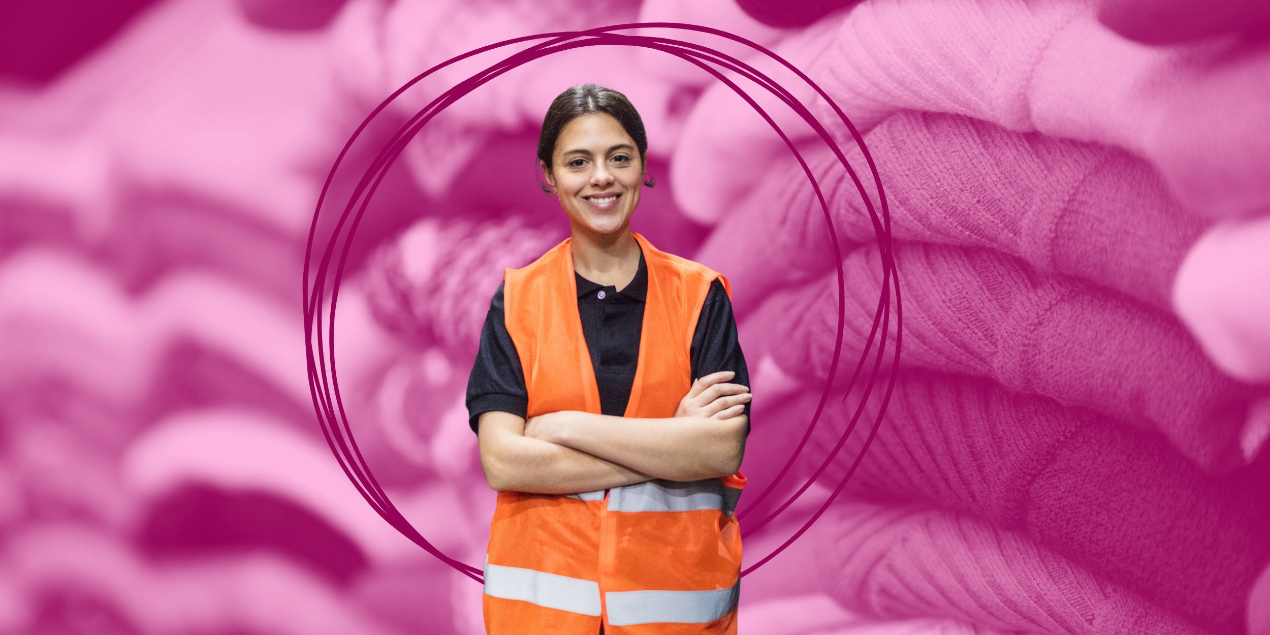 Warehouse worker in a high vis vest in front of a pile of fashion returns