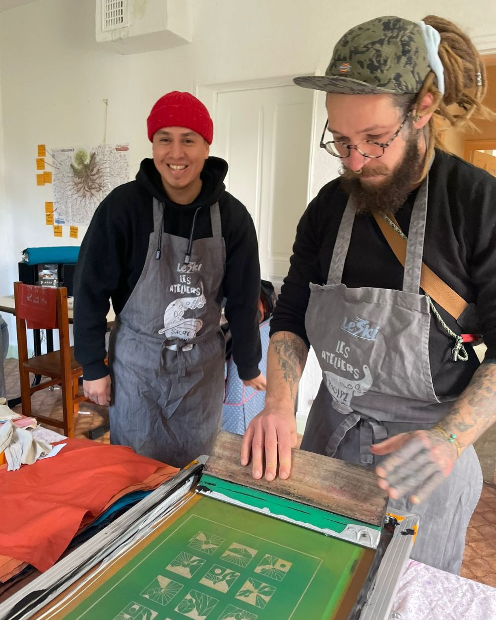 Re-Action Collective Members Working Together Screen Printing in The Hub.