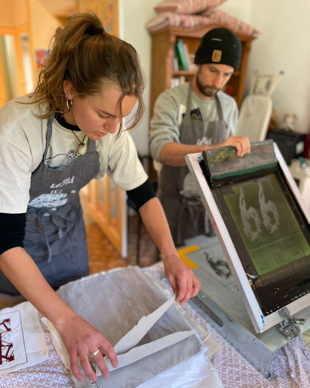 Re-Action Collective Members Working Together Screen Printing in The Hub.