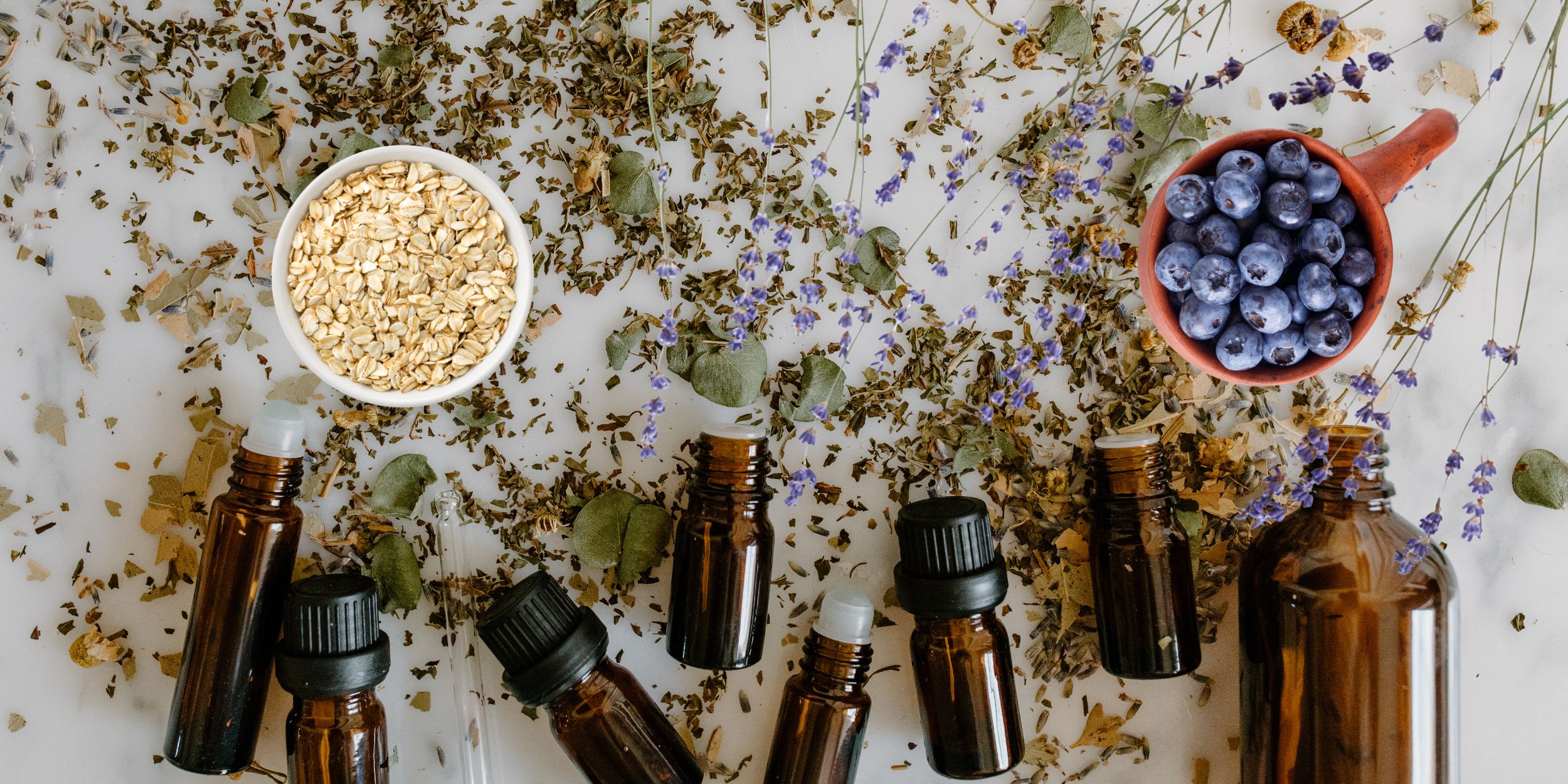 Beauty Industry scorecard image of beuty bottles with various herbs surrounding them