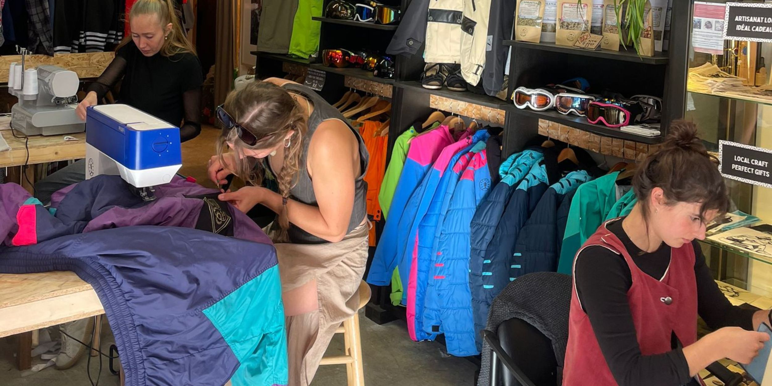 Re-Action Collective Members Repairing Clothing at The Hub.