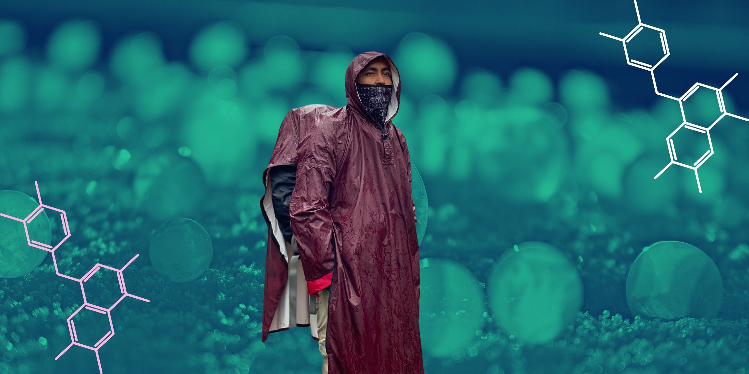 Man standing in a TPU made raincoat and outdoor clothing with snow ice balls in the background