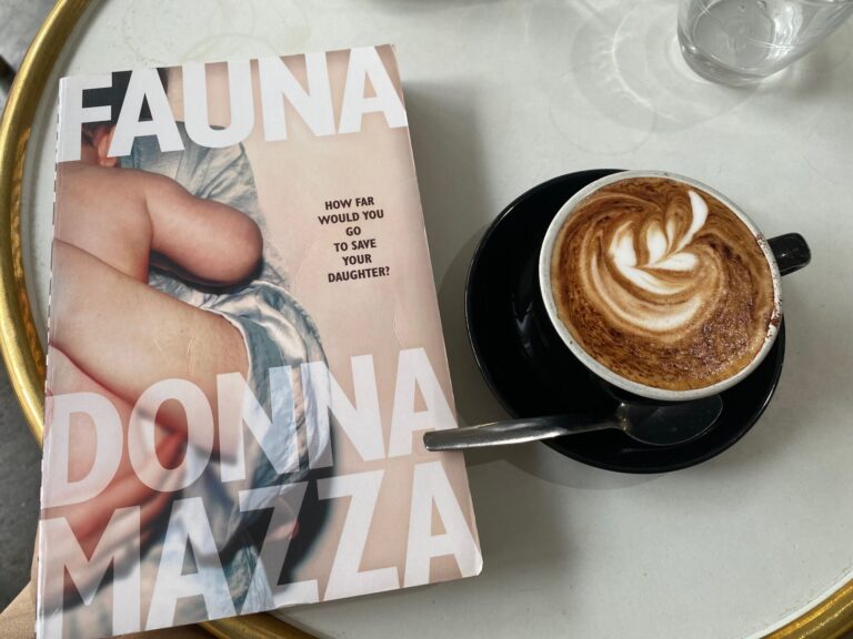 Fauna by Donna Mazza book cover next to a cup of coffee