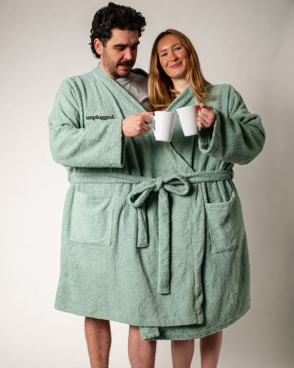 A couple in a Unplugged Reconnect Robe Drinking Coffee Together