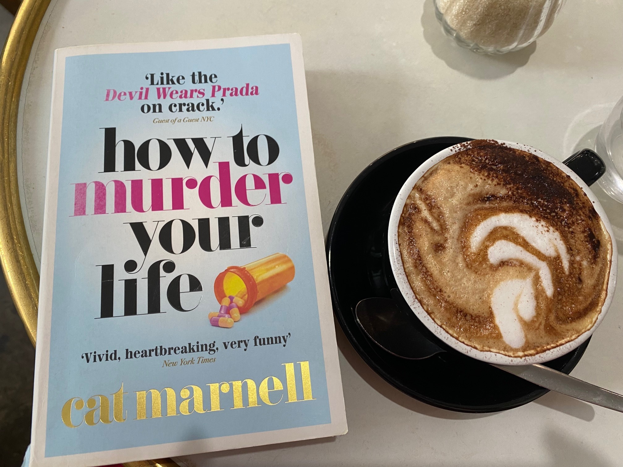 How to murder your life by Cat Marnell book cover next to a cup of coffee