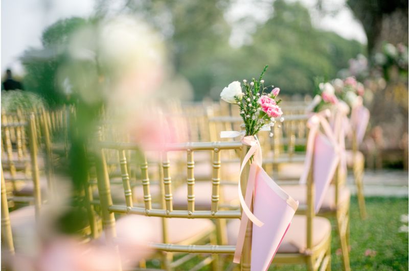 Bridal UK wedding venue outdoor wedding ceremony chairs with flowers and chairs in agarden