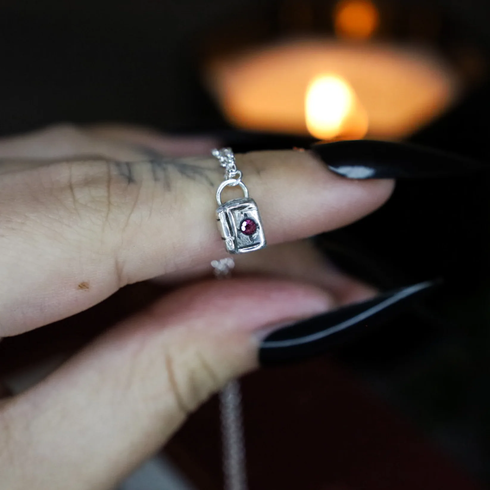 Storms & Saint Grimoire Necklace Made With Silver And Garnet.