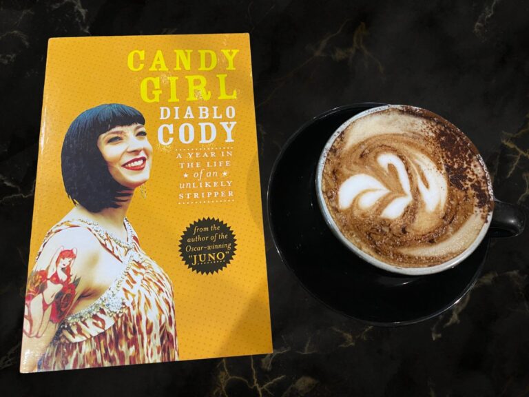 Candy Girl by Diablo Cody book cover next to a cup of coffee on a black marble table top
