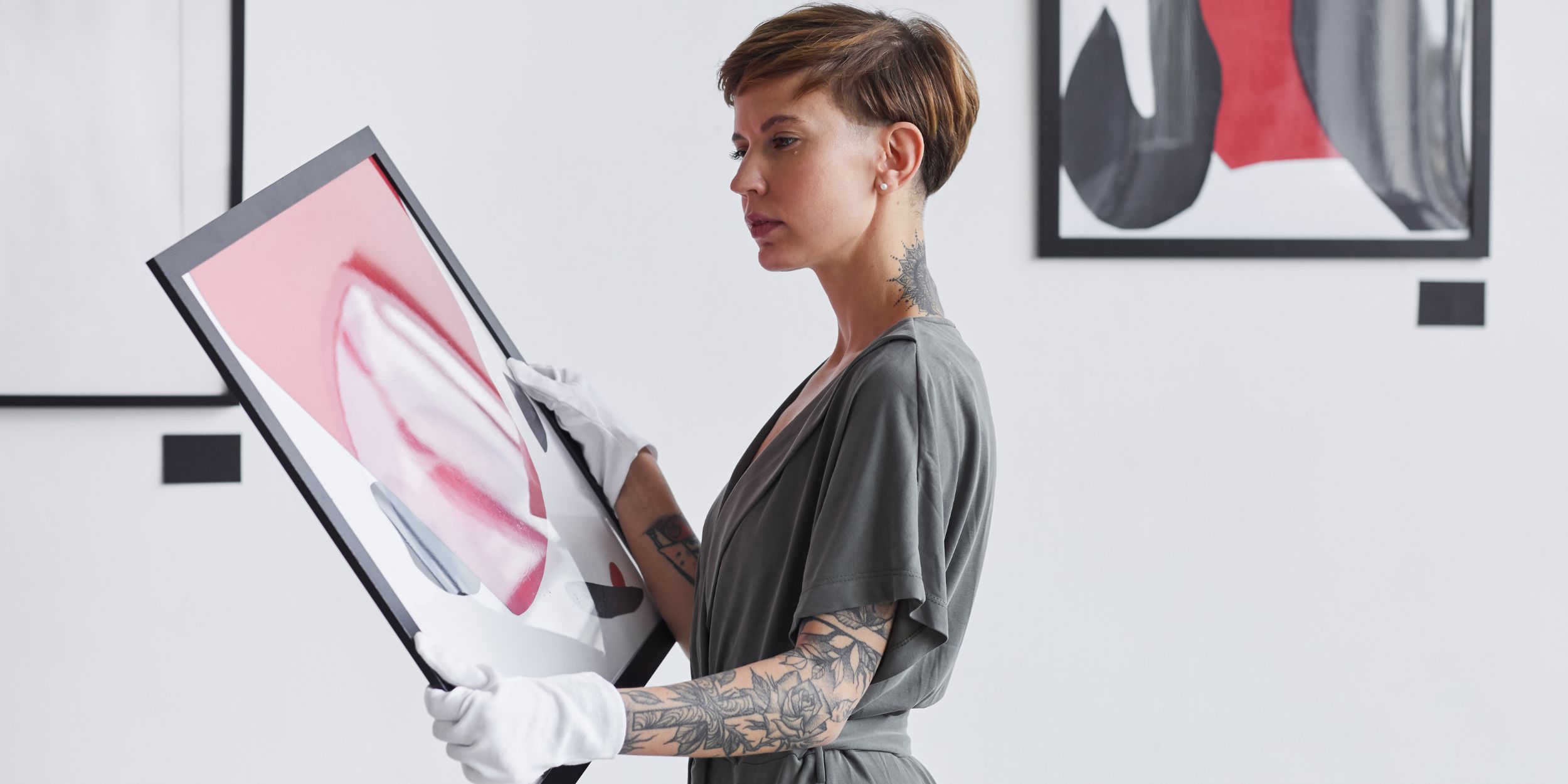 Art collection woman holding an artwork for valuation