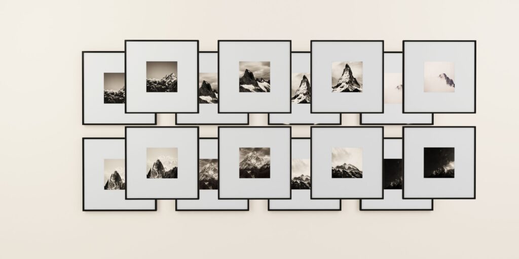 art collection photographs and prints in frames on a wall