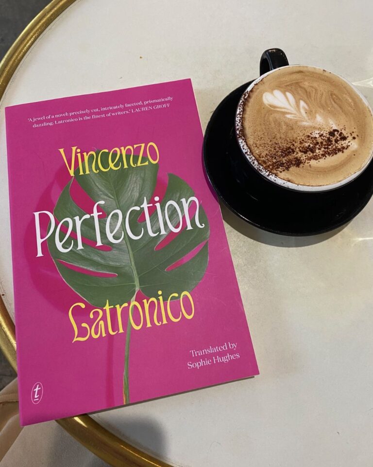Perfection by Vincenzo Latronico book cover on a table next to a cup of coffee