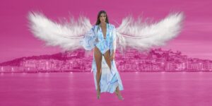 Ibiza fashion Festival PETA Feather free banner, with a model at Ibiza Fashion Festival with Ibiza in the background and two feathers behind her like wings