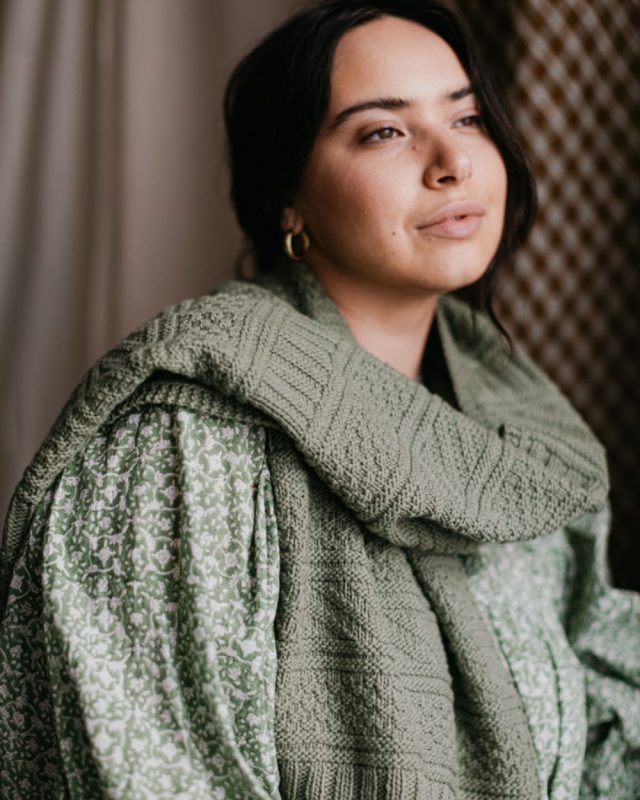 Model wearing the Brooklyn Tweed Essentials Guernsey Wrap Pattern in pale green